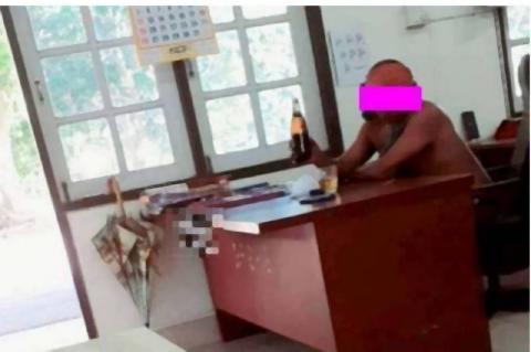 pict-Officer drinking in office.jpg